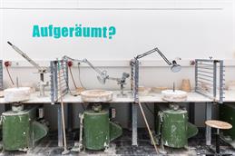 You can see a workstation in the workshop. On the wall is written "Tidy up?