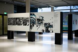 Photo of the information board for the exhibition "Listening to the survivors" in the entrance area of the Design Department.