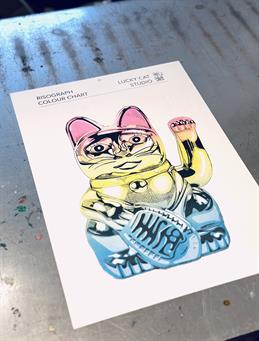 A booth with art prints by Lucky Cat Studio.