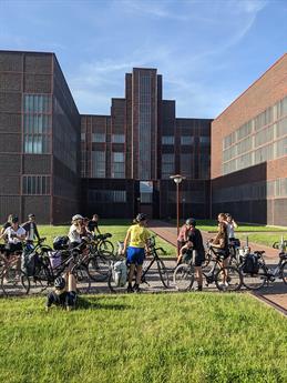 The students are seen with their bicycles in front of the Red Dot Design Museum in Essen.