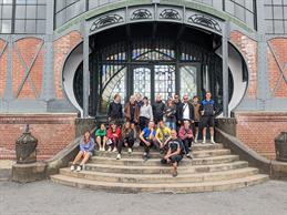 A group photo of the course participants on a staircase.