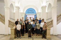 A group photo of the jury and the finalists.