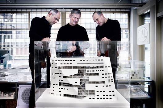 This picture shows Pieter Bannenberg, Walter van Dijk and Kamiel Klaasse standing next to a model in their studio.